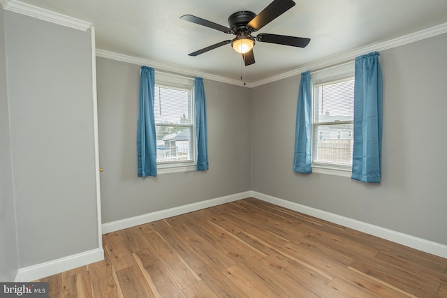 empty room with ceiling fan, crown molding, and light hardwood / wood-style flooring