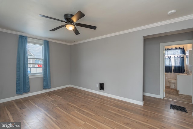 empty room with hardwood / wood-style floors, ceiling fan, and crown molding