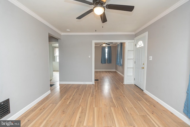 interior space with a wealth of natural light, light wood-type flooring, and ornamental molding