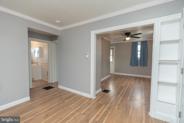 unfurnished room featuring wood-type flooring, ceiling fan, and ornamental molding