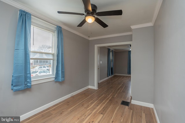 spare room featuring hardwood / wood-style flooring, ceiling fan, and ornamental molding