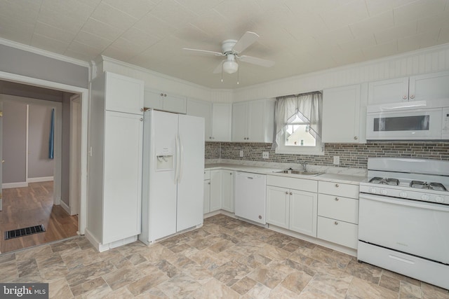 kitchen featuring white appliances, sink, ceiling fan, ornamental molding, and white cabinetry