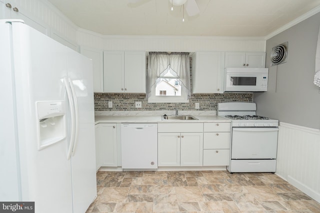 kitchen with ceiling fan, sink, white appliances, white cabinets, and ornamental molding