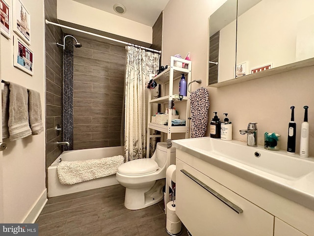 full bathroom with hardwood / wood-style floors, vanity, toilet, and shower / bath combo with shower curtain