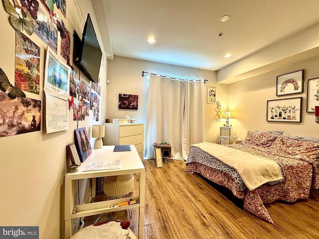 bedroom with hardwood / wood-style floors