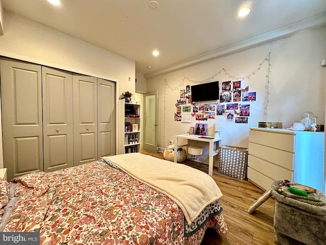 bedroom featuring a closet and light hardwood / wood-style flooring