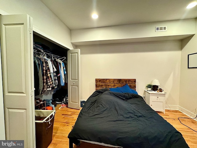 bedroom featuring light wood-type flooring and a closet