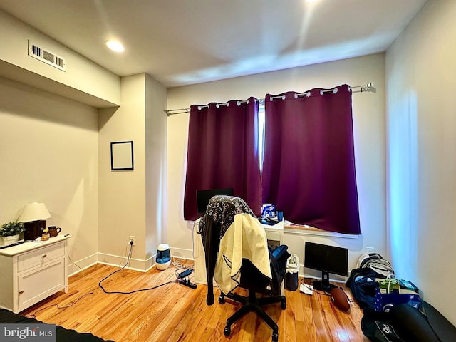 home office with light hardwood / wood-style flooring