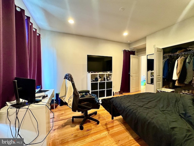 bedroom featuring a closet and light hardwood / wood-style flooring