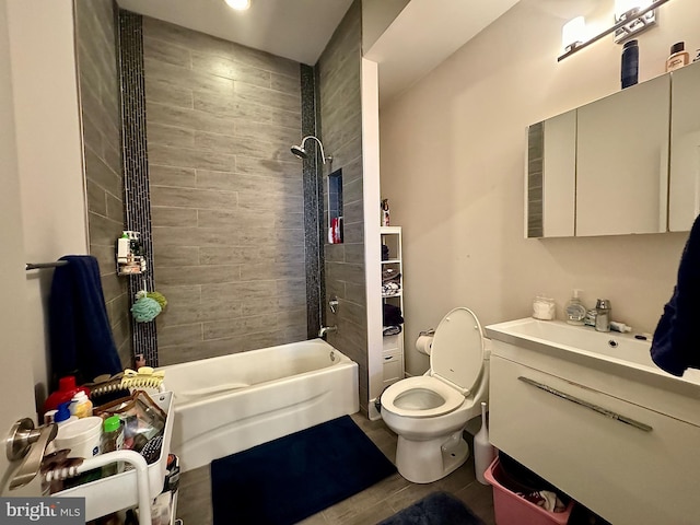 full bathroom with vanity, tiled shower / bath combo, and toilet