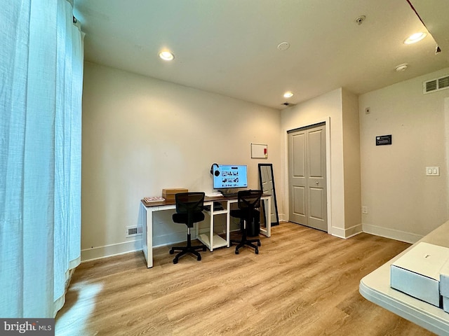 office area with light hardwood / wood-style floors