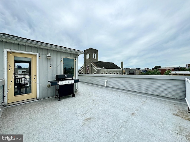 view of patio with grilling area and a balcony