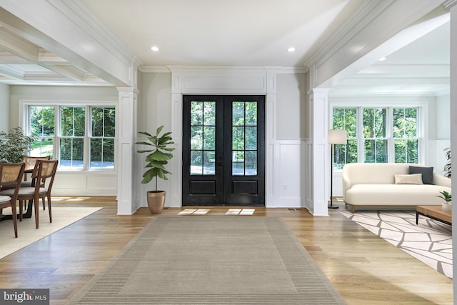 foyer featuring a wealth of natural light, light hardwood / wood-style flooring, and beamed ceiling