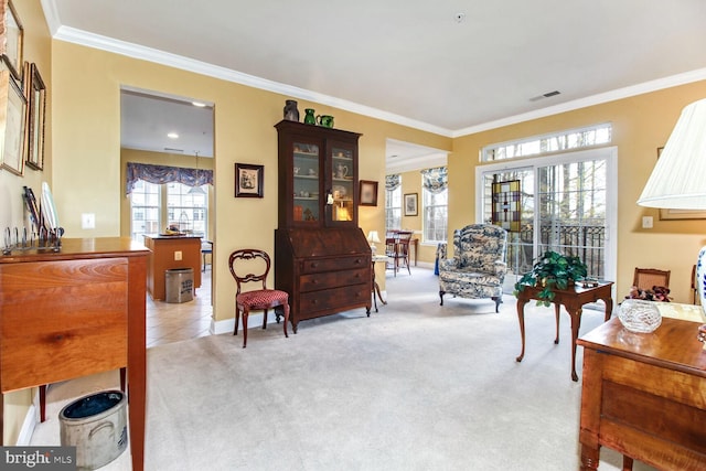 sitting room with light colored carpet and crown molding