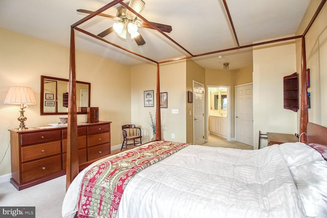 bedroom with ensuite bathroom, ceiling fan, and light colored carpet