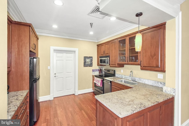 kitchen with light stone countertops, sink, stainless steel appliances, decorative light fixtures, and ornamental molding