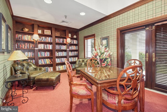 carpeted dining room with built in shelves and crown molding