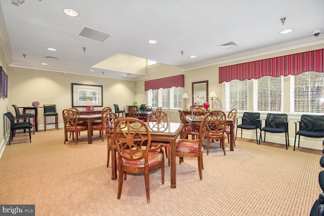 dining space with light colored carpet and crown molding