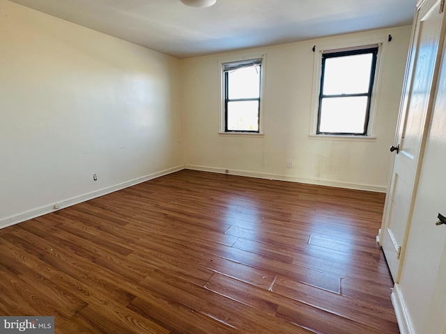 unfurnished room featuring dark hardwood / wood-style flooring