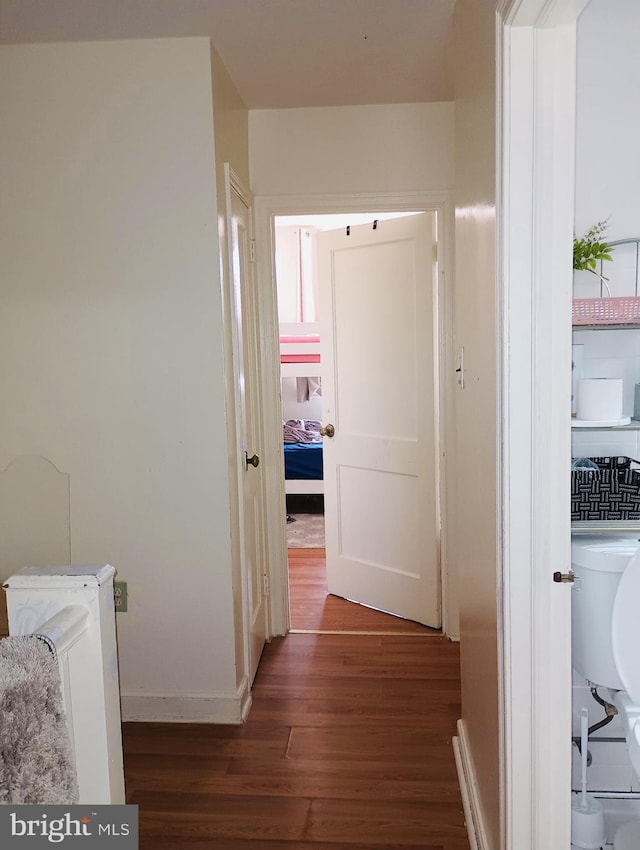 hallway with dark hardwood / wood-style flooring