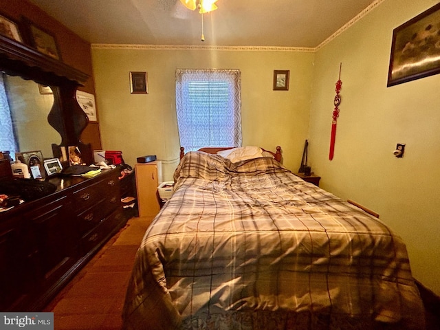 bedroom with ceiling fan, hardwood / wood-style floors, and ornamental molding