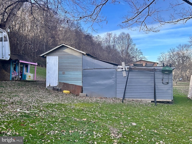 view of outbuilding featuring a yard