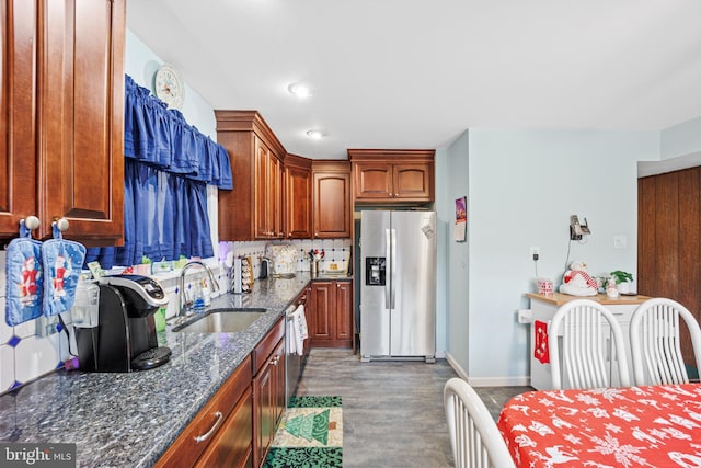 kitchen with sink, stainless steel fridge with ice dispenser, backsplash, dark stone countertops, and hardwood / wood-style floors