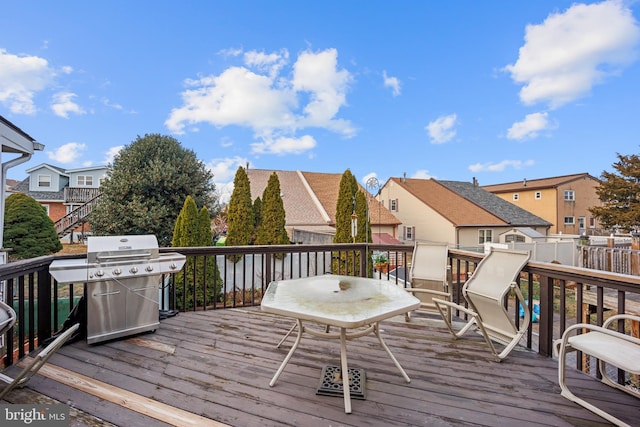 wooden deck featuring a grill