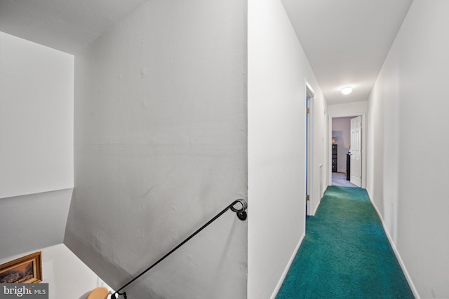 hallway featuring dark colored carpet