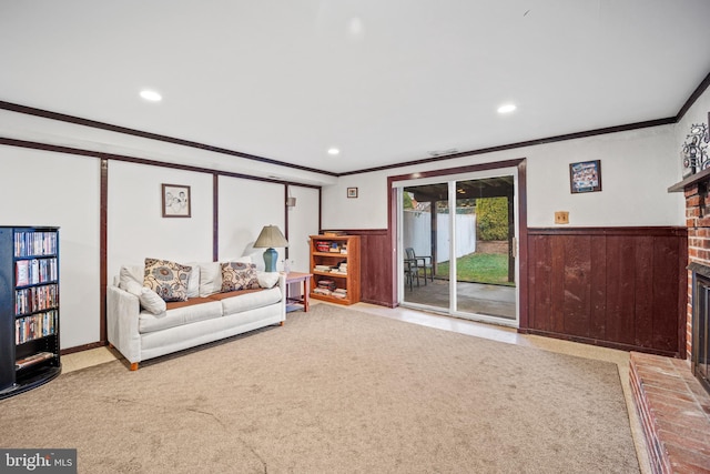 living room with a fireplace, light colored carpet, and ornamental molding