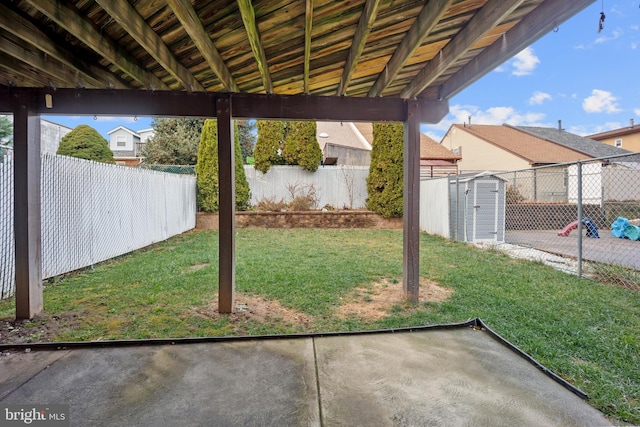 view of yard with a patio and a storage shed