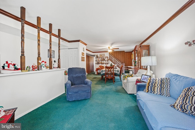 carpeted living room with crown molding and ceiling fan