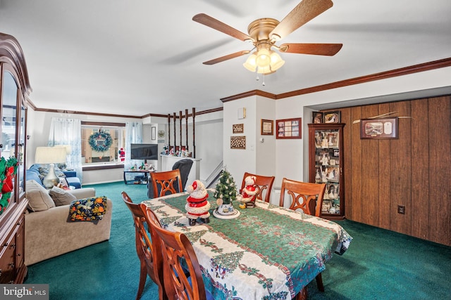 carpeted dining room with ceiling fan and ornamental molding