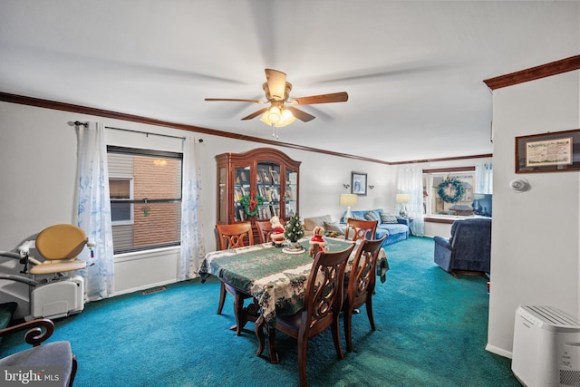 dining room with carpet flooring, ceiling fan, a healthy amount of sunlight, and ornamental molding