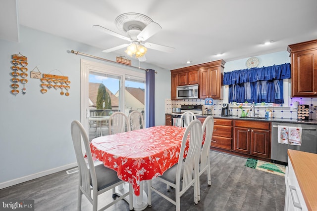 dining area with dark hardwood / wood-style floors, ceiling fan, and sink