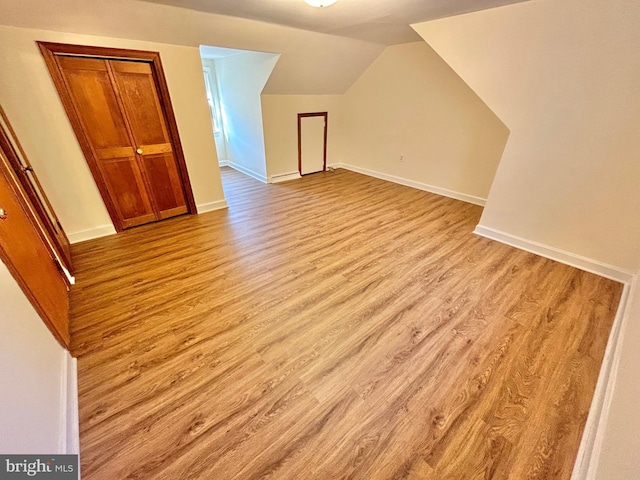 bonus room featuring light hardwood / wood-style floors and lofted ceiling