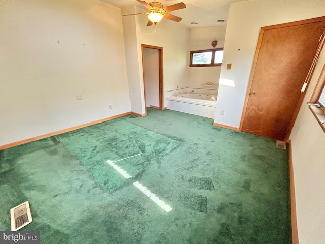 unfurnished bedroom featuring carpet flooring, ceiling fan, and vaulted ceiling