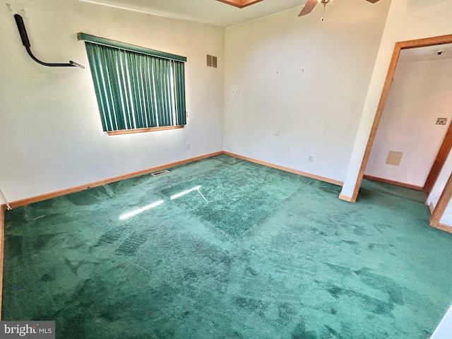 empty room featuring carpet flooring and ceiling fan