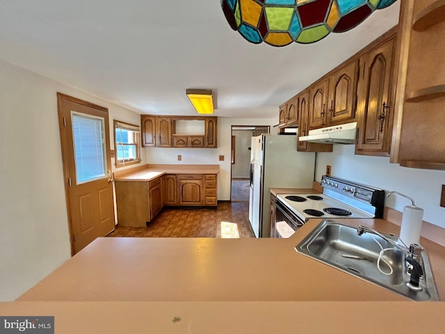 kitchen featuring kitchen peninsula, electric range, and sink