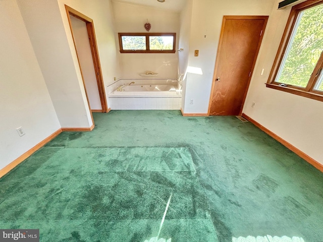 bathroom featuring tiled bath and vaulted ceiling