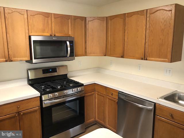 kitchen with sink and appliances with stainless steel finishes