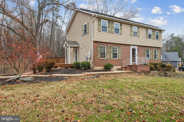 view of front of property with a front lawn and a wooden deck