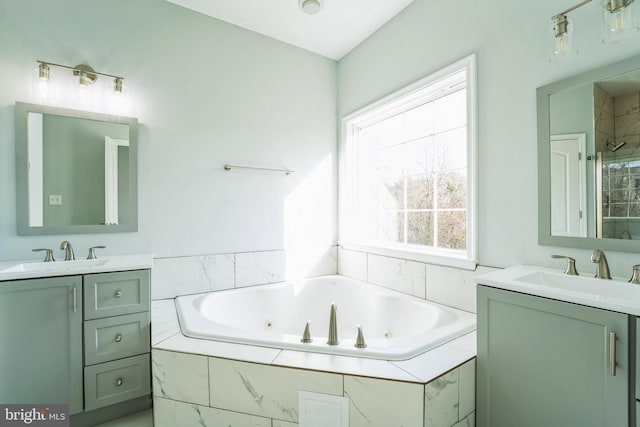 bathroom with vanity and independent shower and bath