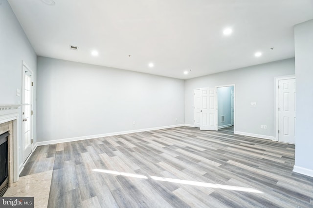 unfurnished living room featuring light wood-type flooring