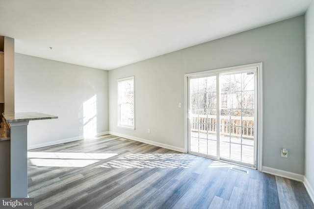 unfurnished living room featuring light hardwood / wood-style flooring and a healthy amount of sunlight