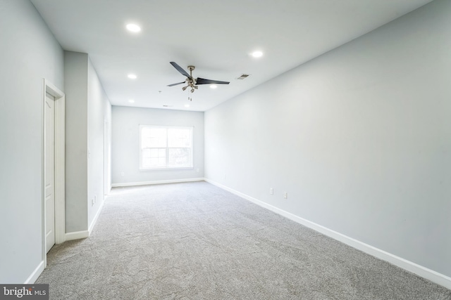 carpeted empty room featuring ceiling fan