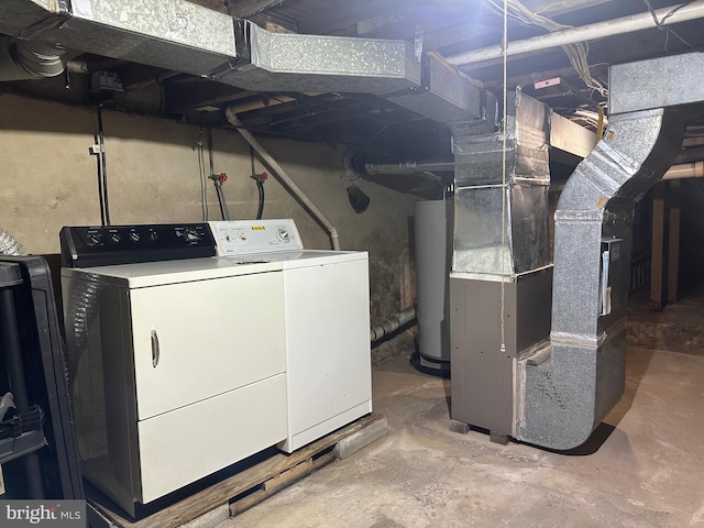 laundry room featuring washer and clothes dryer, gas water heater, and heating unit