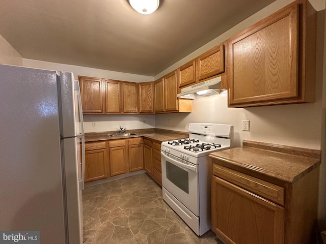 kitchen featuring sink and white appliances