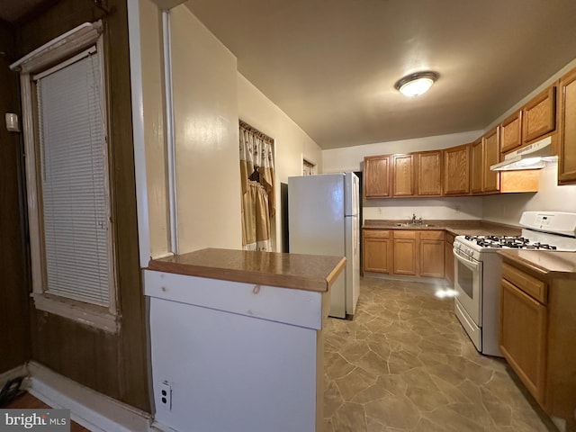 kitchen featuring white appliances and sink