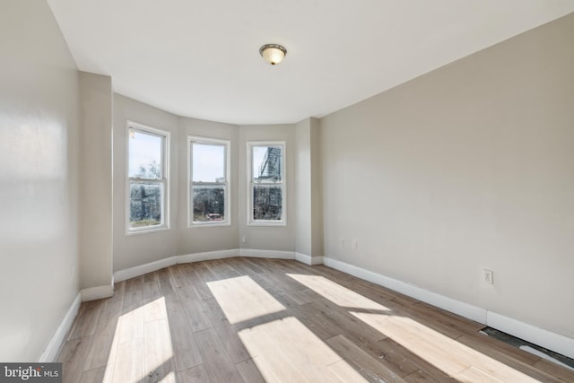 spare room with light wood-type flooring